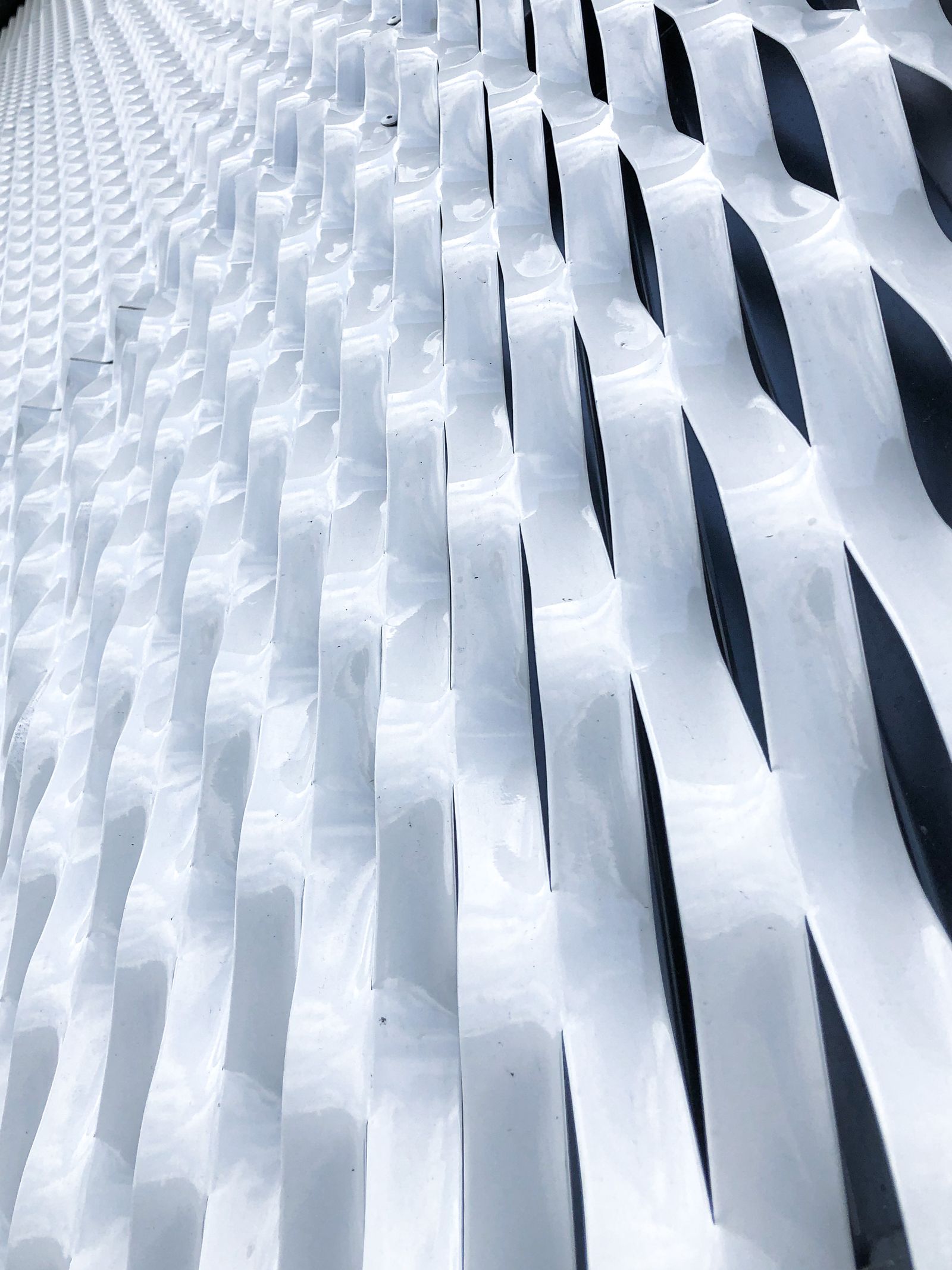 Brushed metal wave facade cladding detail