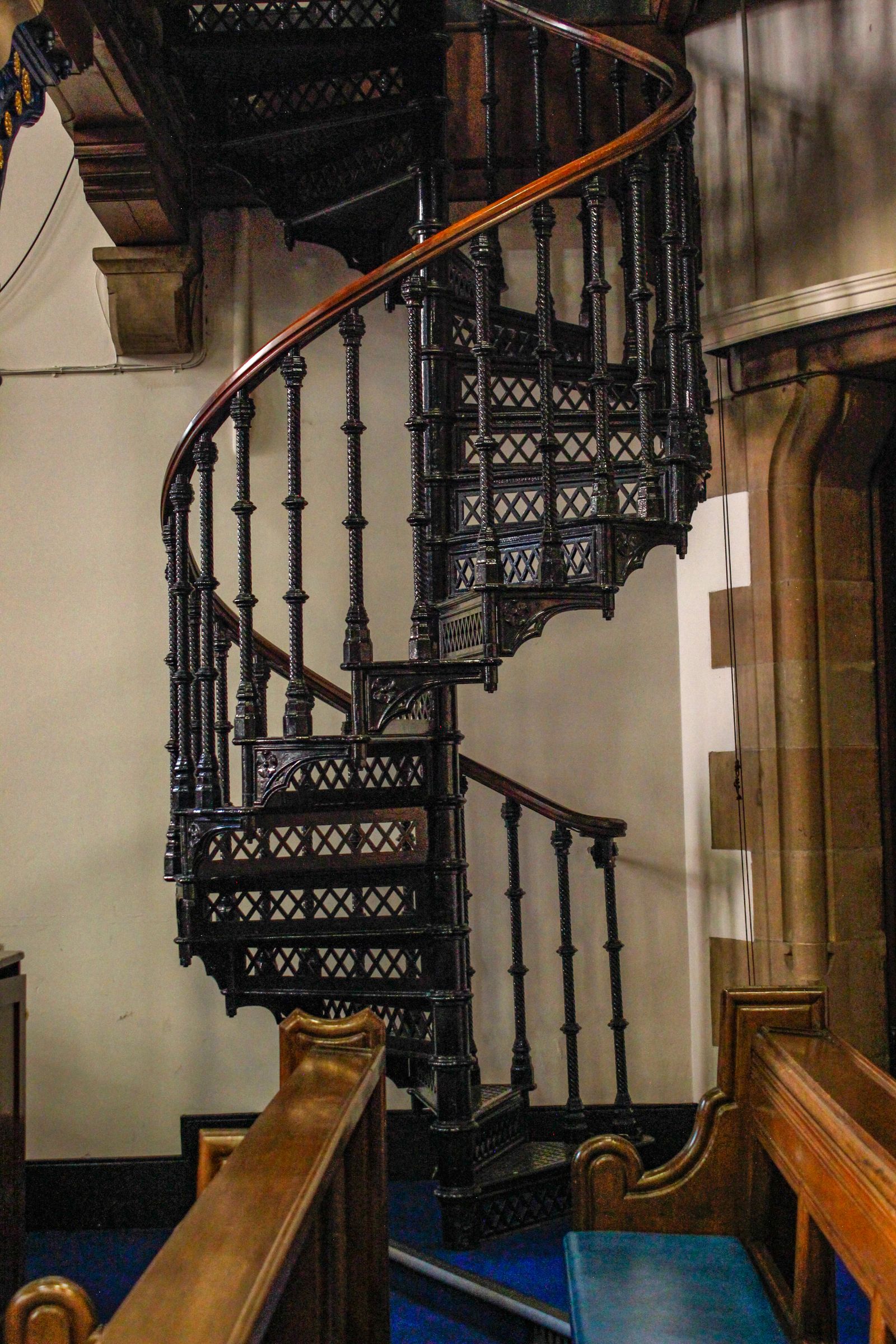 Ornate black metal spiral staircase with detailed railings