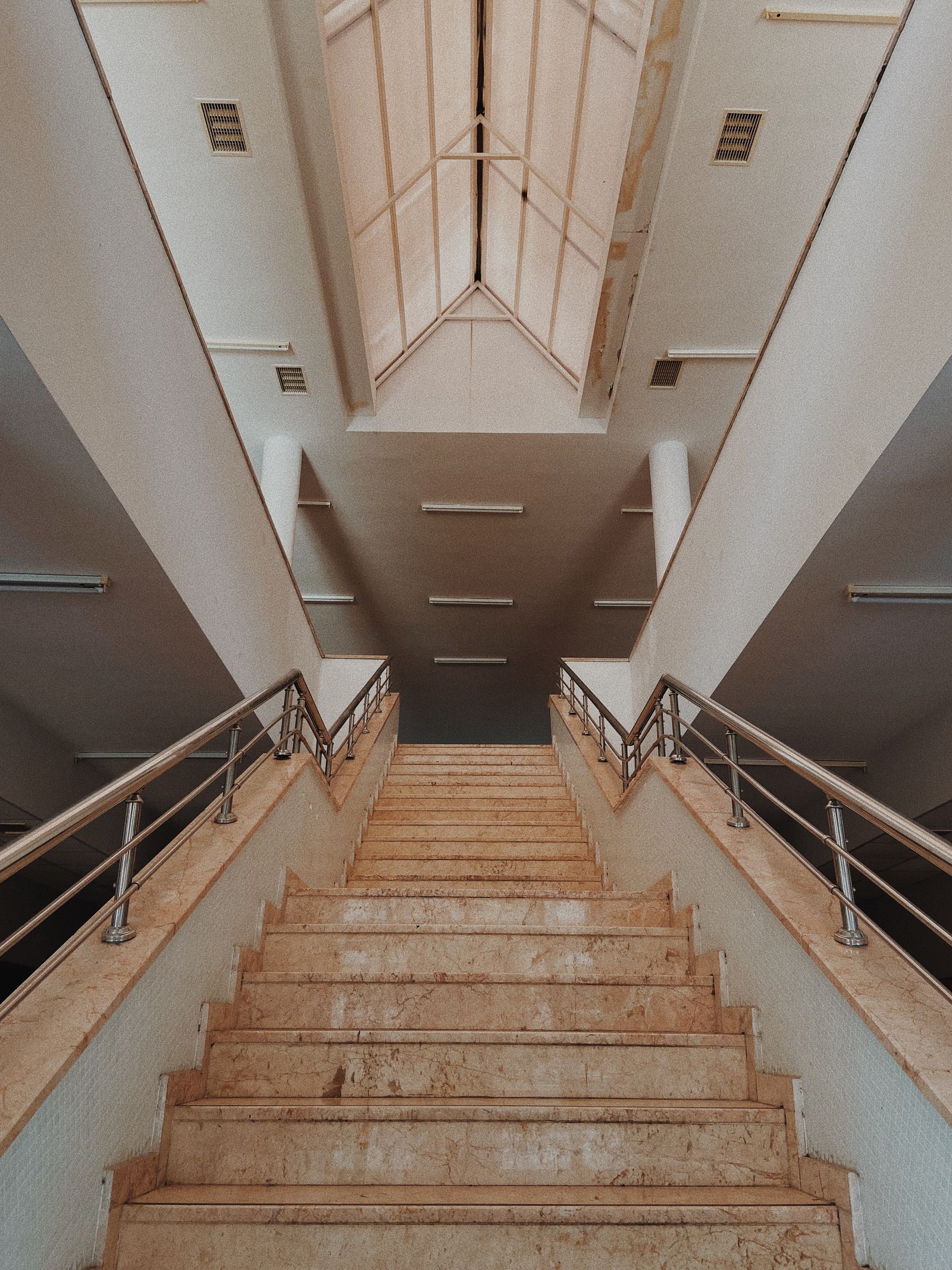 Modern staircase with polished stainless steel handrails
