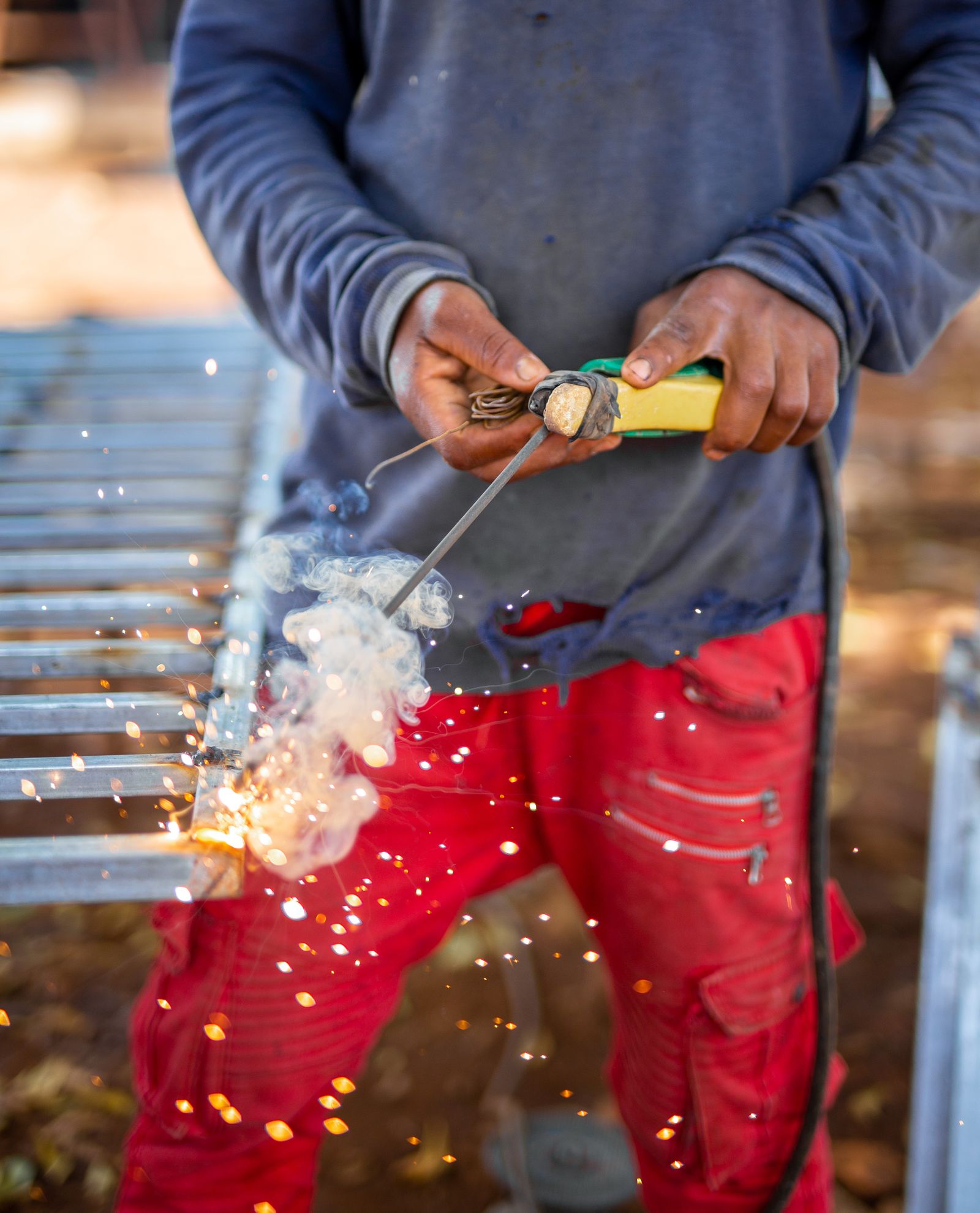 Close-up of metal being welded with bright sparks